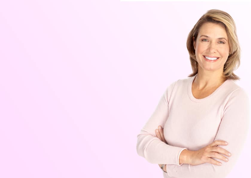 Woman with arms crossed in pink sweater