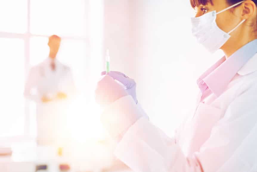 female doctor holding syringe with injection