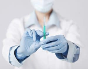 stockfresh 4557461 female doctor holding syringe with injection sizeS