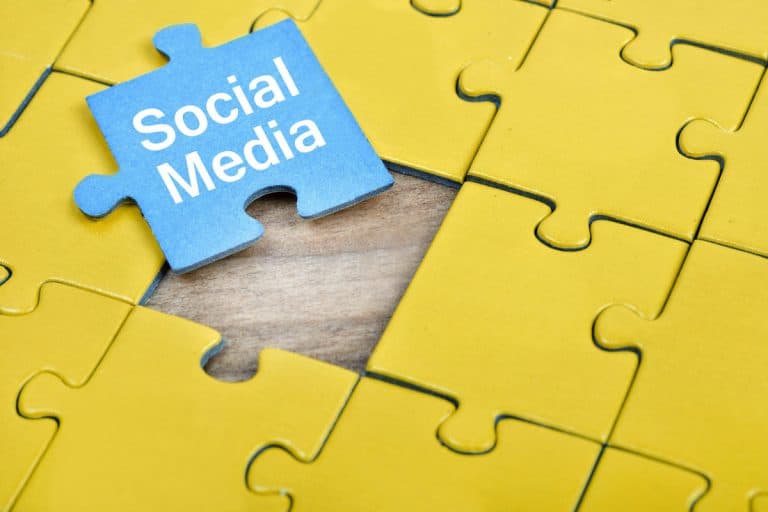 Yellow puzzle pieces with blue Social Media piece sitting on top