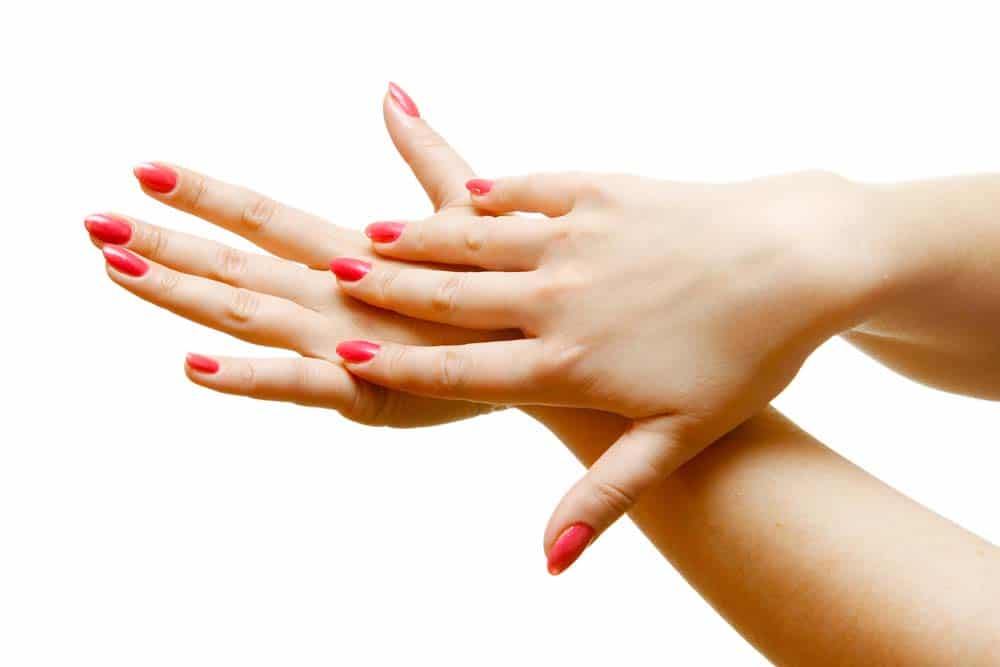 Woman with painted nails showing her hands