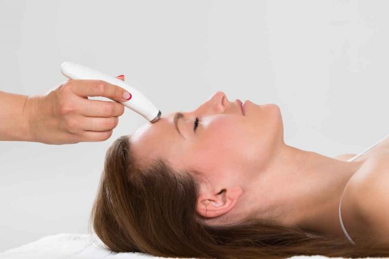 Woman having microdermabrasion therapy
