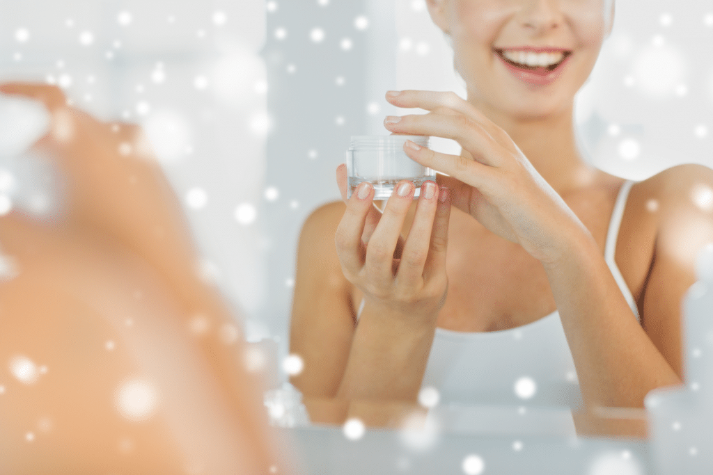 Smiling young woman holding a small jar of face cream