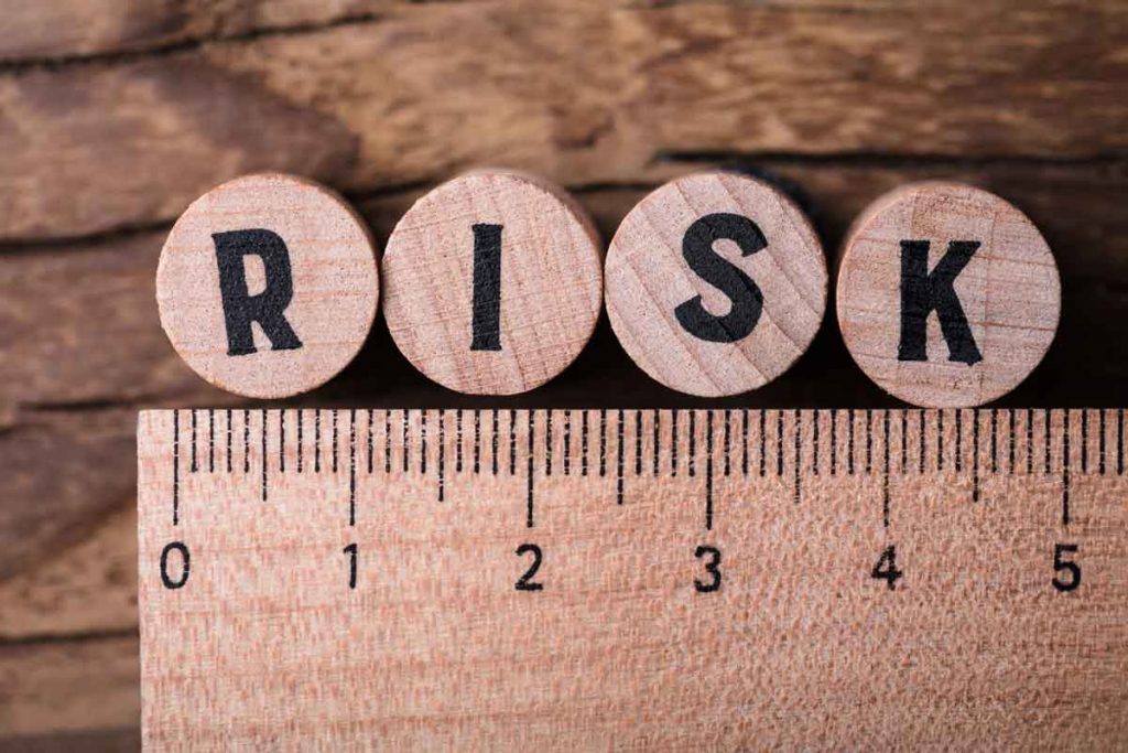 Risk-Assessment printed on round wooden game disks with wooden ruler beneath