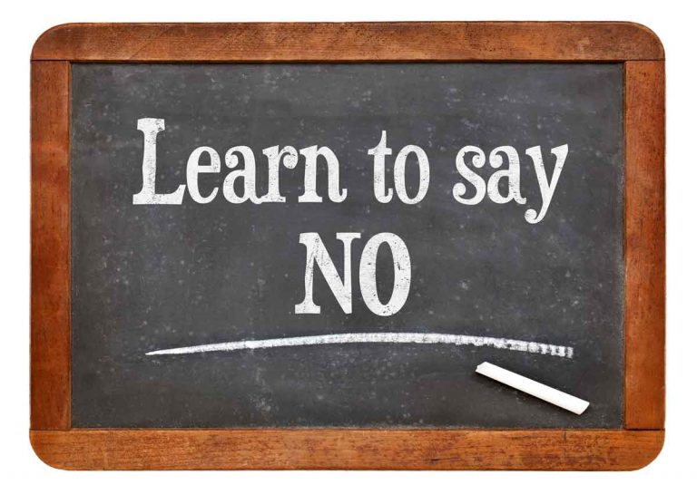 tutorial or advice concept - learn to say no- white chalk text on a vintage slate blackboard