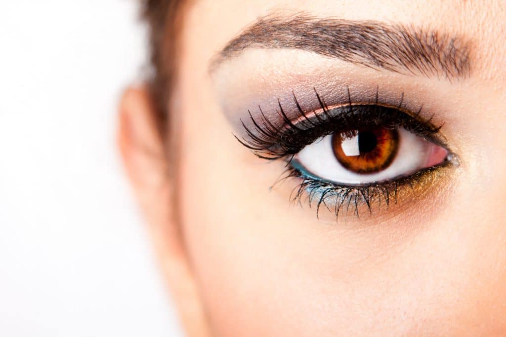 Fashion beautiful female brown watchful eye with long black eyelashes mascara