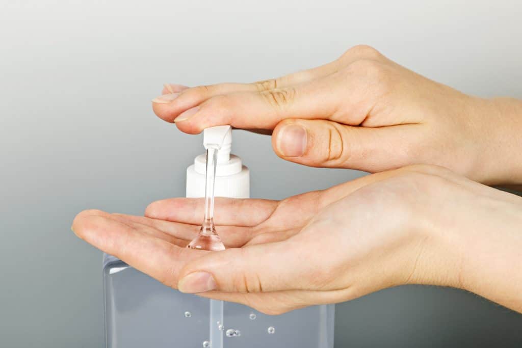 Woman putting sanitizing gel on hands