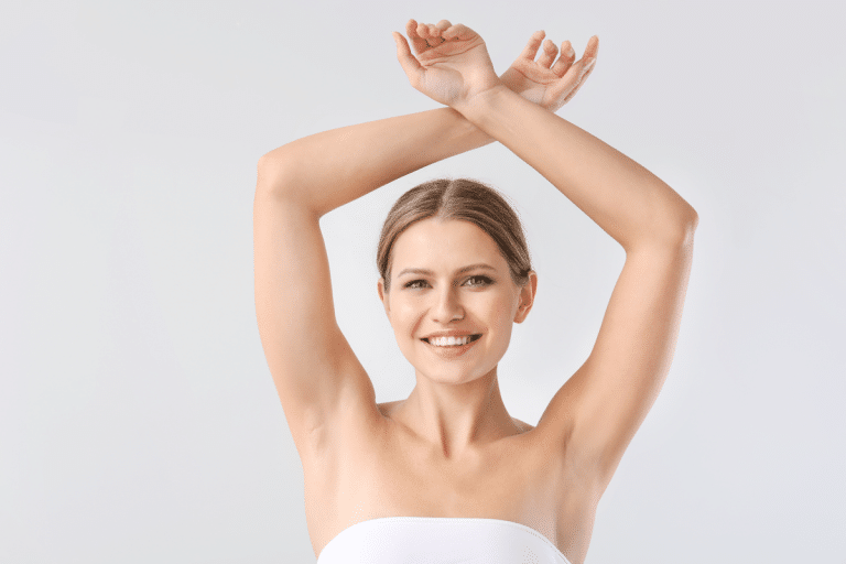 Smiling woman with hands over her head after Laser Hair Removal Services